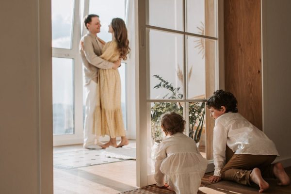 A joyful family moment indoors with parents and children enjoying a cozy home environment.